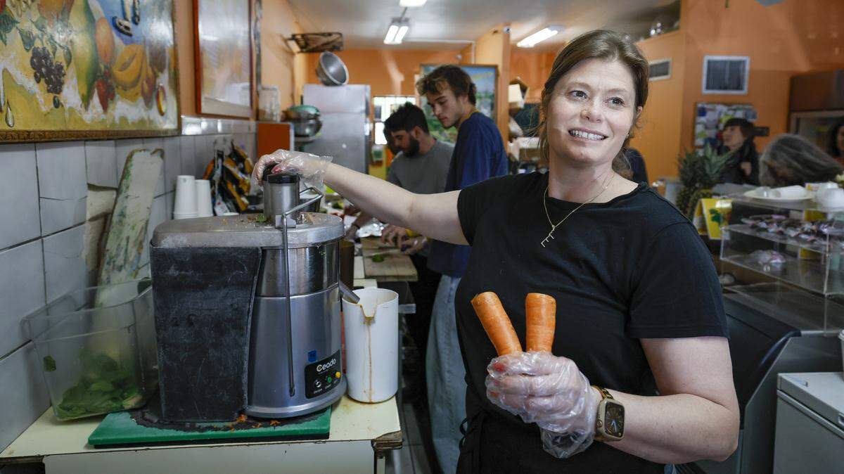 Erin Compton, the owner of The Last Carrot, prepares carrot juice for customers at the Coconut Grove restaurant. Located in a modest strip mall, The Last Carrot is closing after more than 50 years.
