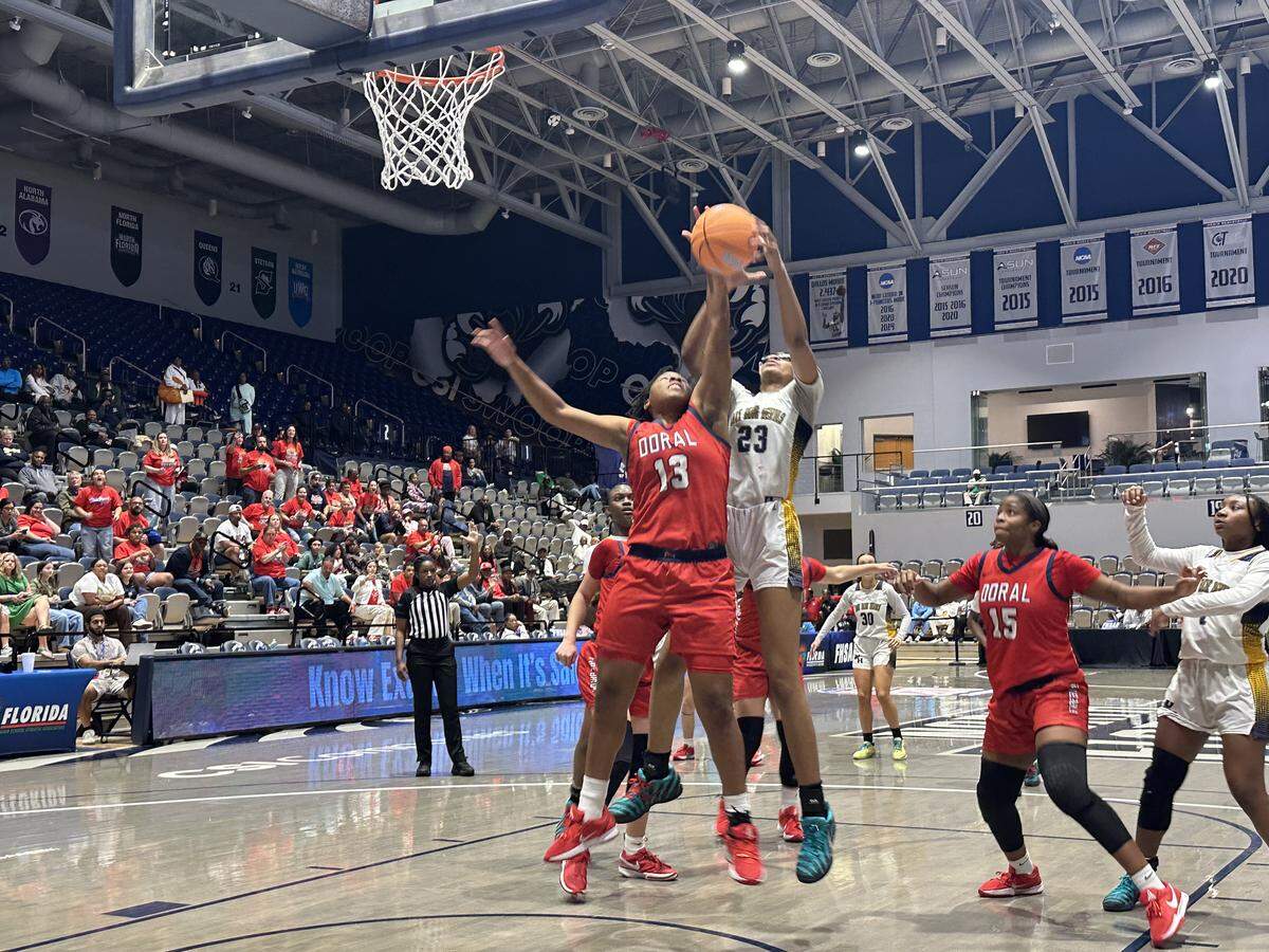 Doral Academy’s DJ Myers (13) battles Winter Haven’s Victoria Hall (23) for a rebound during Saturday’s Class 7A state championship game at UNF Arena in Jacksonville, Fla.
