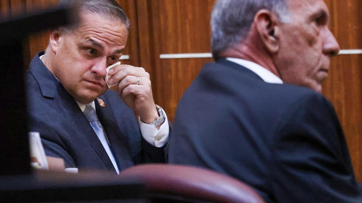 Frank Artiles, left, wipes away tears as his wife speaks on his behalf during his sentencing Monday, Nov. 18, 2024, at the Miami-Dade County Courthouse. The former Florida state legislator, a Republican, was sentenced to 60 days in jail and five years probation after he was convicted of a campaign scheme that likely stole the election of a Florida Democratic state senator.
