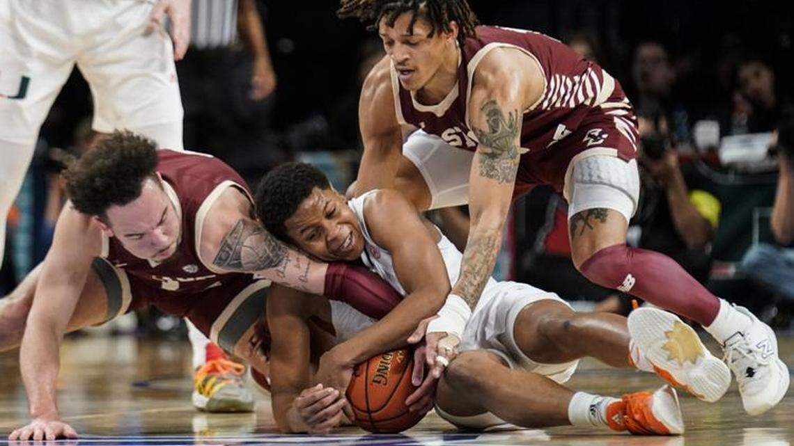University of Miami point guard Charlie Moore wrestles the ball away from Boston Cullege during a 71-69 overtime win in the ACC tournament quarterfinal at the Barclays Center in Brooklyn, NY on Mar. 10, 2022.