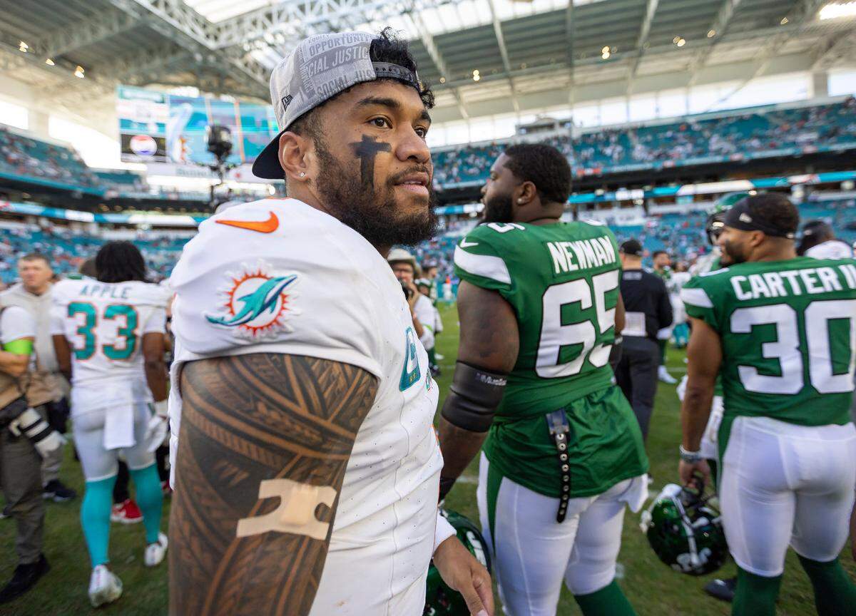 Miami Dolphins quarterback Tua Tagovailoa (1) looks on from the field after defeating the New York Jets in their NFL game at Hard Rock Stadium on Sunday, Dec. 17, 2023, in Miami Gardens, Fla.