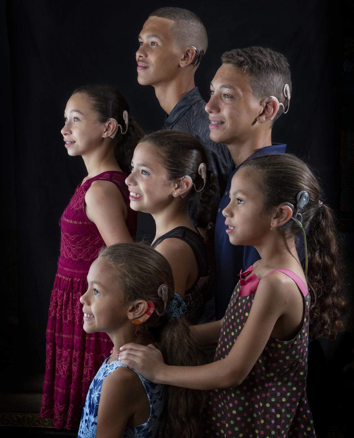 Back row: left to right: Matthew, 16, Marcus, 15. Middle row: from left, Michelle, 13, Maria, 10, Marcia, 6. Front row:  Miley, 8. The six siblings, members of the Guillou family, were all born deaf.  Over the past eight years, the children have been surgically fitted with cochlear implants through the University of Miami Health System, which have allowed them to hear.