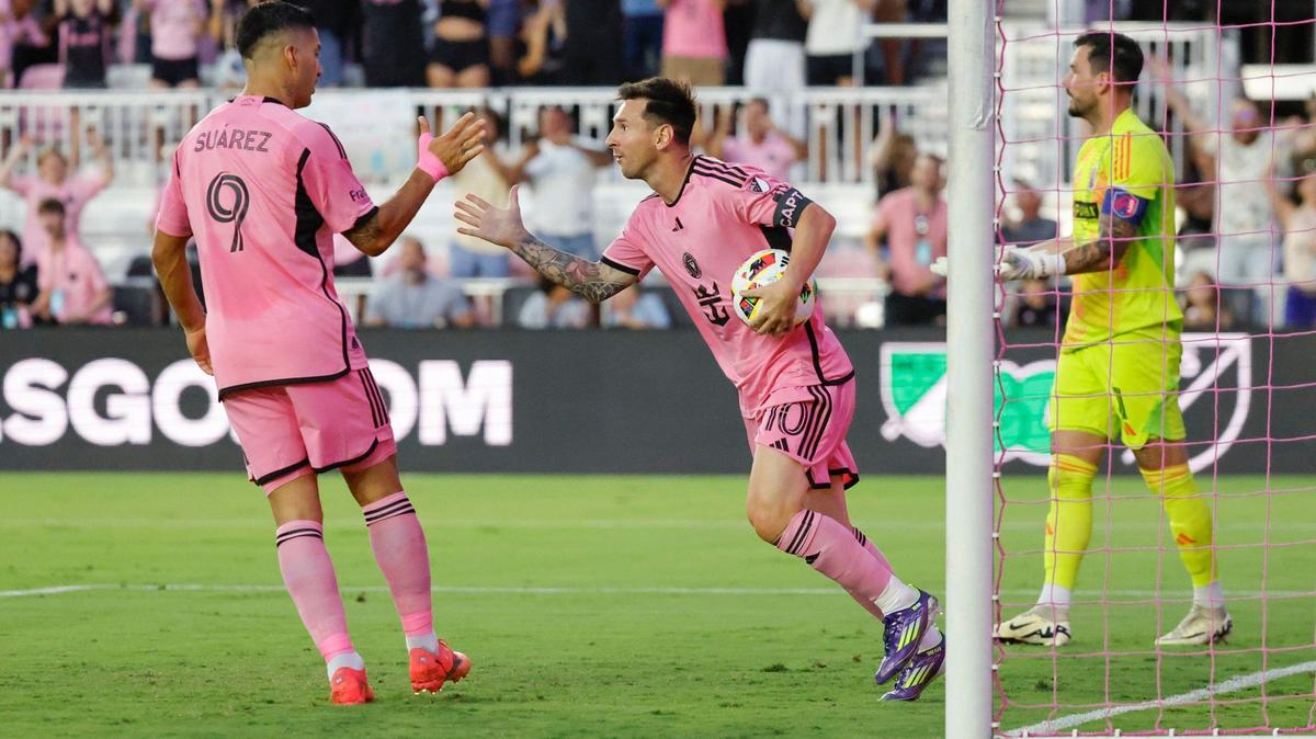 Inter Miami forward Lionel Messi (10) picks up the soccer ball after scoring in the first half as he celebrates with forward Luis Suárez (9) during the match against St. Louis at Chase Stadium in Fort Lauderdale, Fla. on Saturday, June 1, 2024.