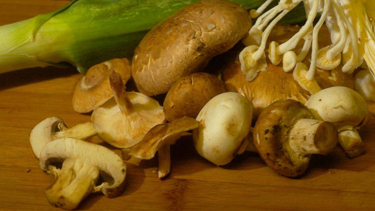 File photo from 2006 of creminis, shiitakes, portabellos and enoki mushrooms. The enokis are the thin, white bulbs at top right.