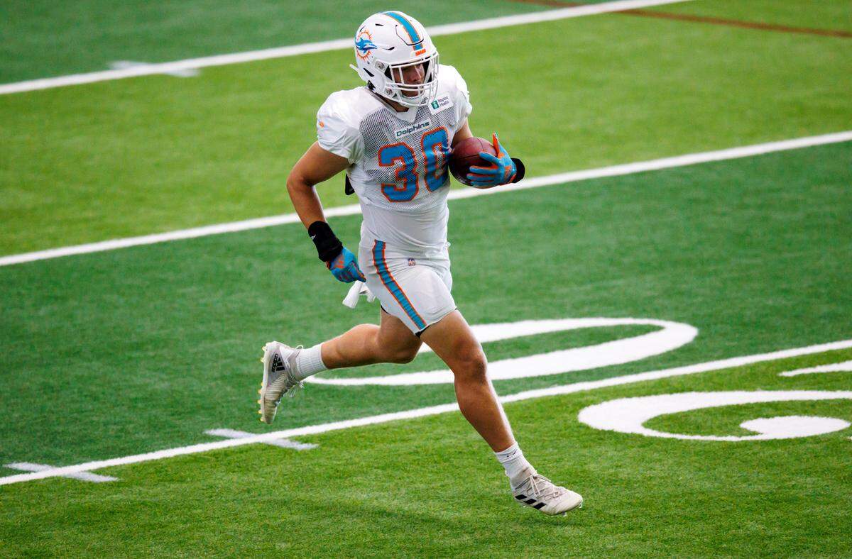 Miami Dolphins fullback Alec Ingold (30) runs with the football during NFL football training camp at Baptist Health Training Complex in Hard Rock Stadium on Thursday, August 23, 2022 in Miami Gardens, Florida.