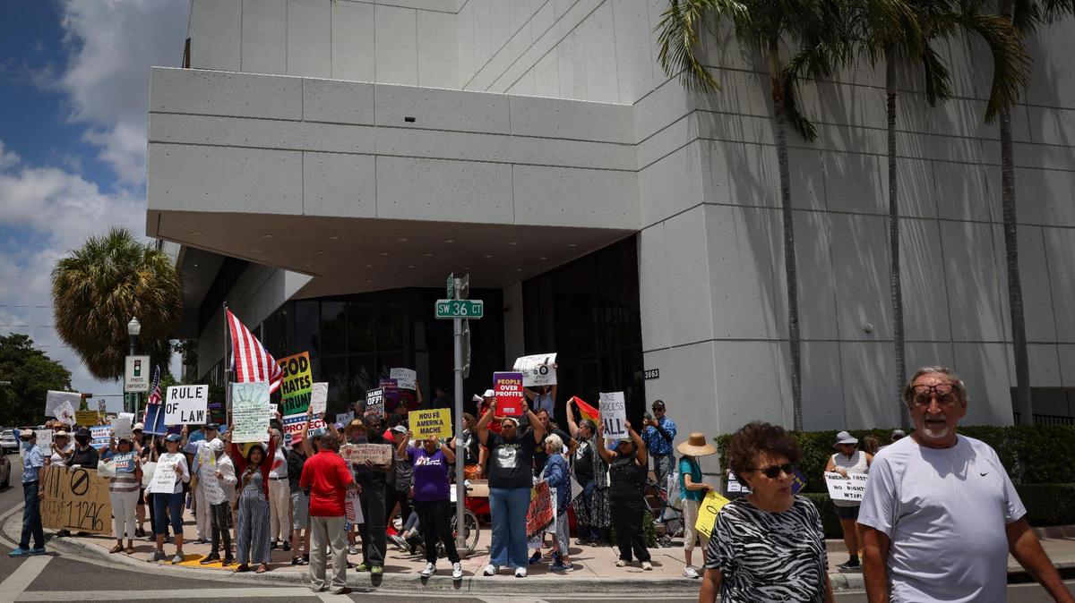 People gather outside of the Social Security Administration building during a May Day rally themed “Protect Social Security, Protect Workers” on Thursday, May 1, 2025, in Miami.