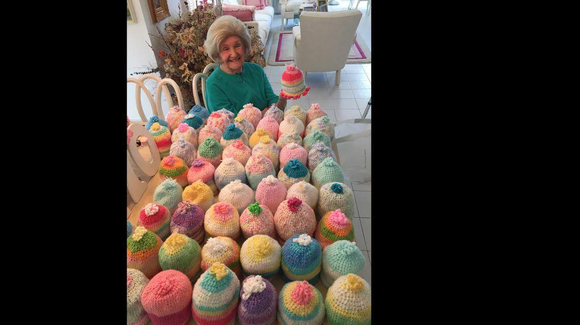 Mazie Ford and the hats she crocheted for newborns.