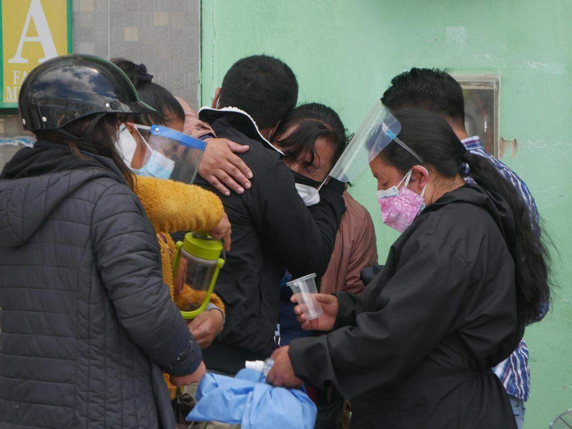 Relatives of a COVID-19 patient in critical condition console one another outside a hospital in Cajamarca, Peru, on May 8, 2021.