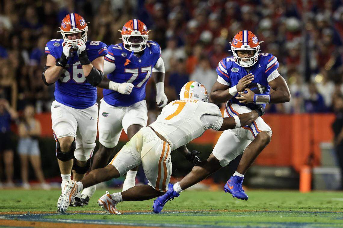 GAINESVILLE, FLORIDA - NOVEMBER 22: DJ Lagway #2 of the Florida Gators runs with the ball against Arion Carter #7 of the Tennessee Volunteers during the first half of a game at Ben Hill Griffin Stadium on November 22, 2025 in Gainesville, Florida. (Photo by James Gilbert/Getty Images)