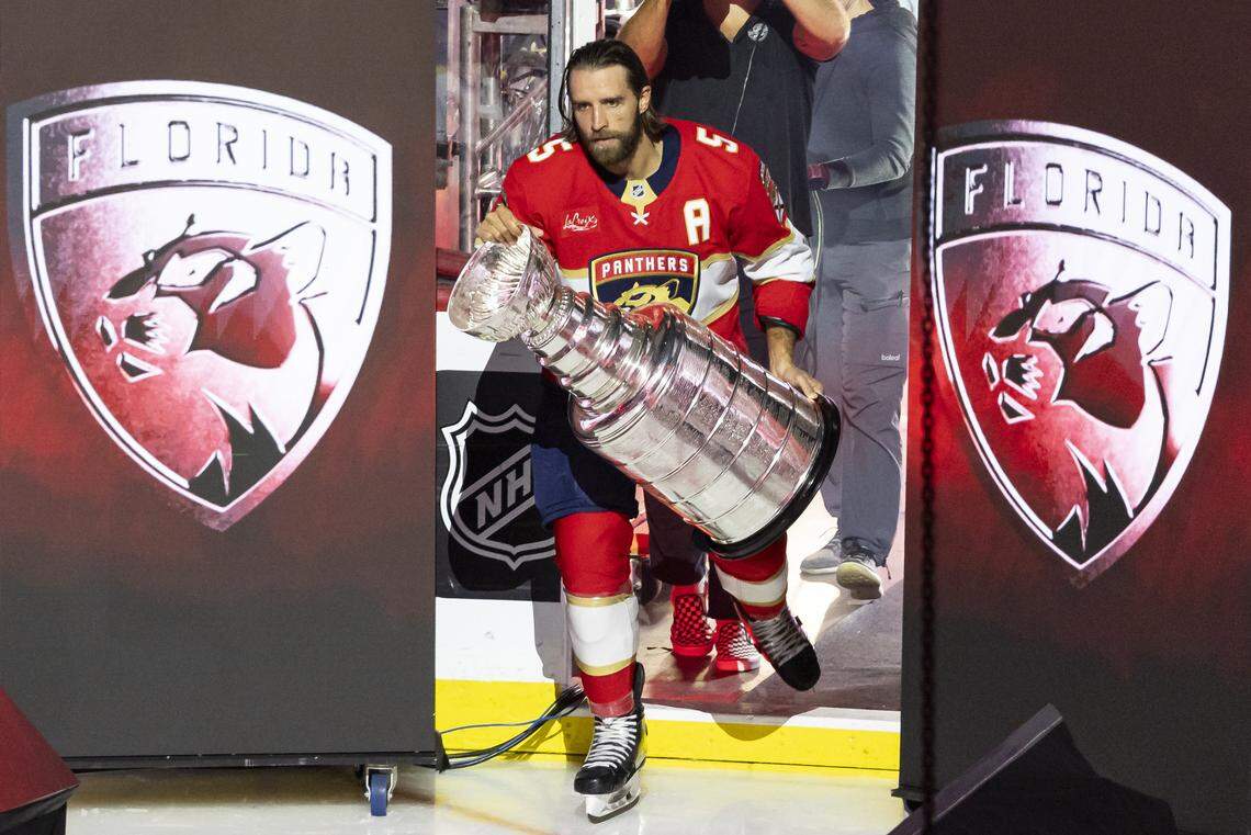Florida Panthers defenseman Aaron Ekblad (5) enters the ice with the Stanley Cup prior to raising the Stanley Cup Champions banner before their home opener against the Chicago Blackhawks at the Amerant Bank Arena on Oct. 7, 2025 in Sunrise, Fla.