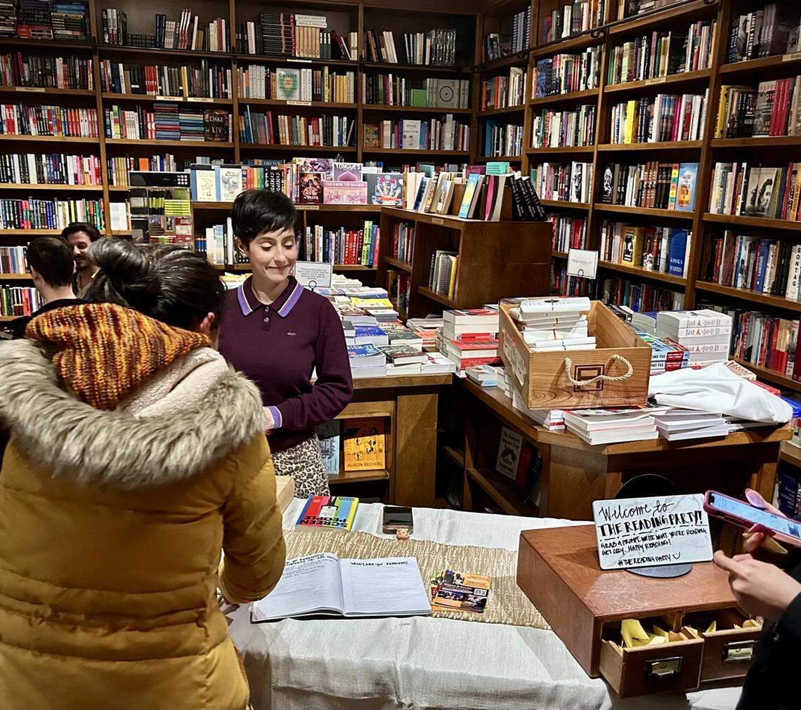 Alyssa Expósito, the program coordinator for the Books & Books Literary Foundation, welcomes people as they sign in for the reading party.