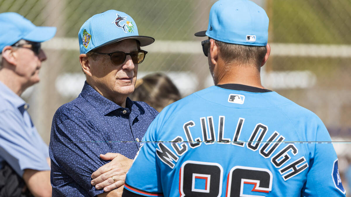 Miami Marlins owner Bruce Sherman talks with manager Clayton McCullough (86) during the team’s first full-squad spring training workout at Roger Dean Stadium on Monday, Feb. 16, 2026, in Jupiter, Fla.