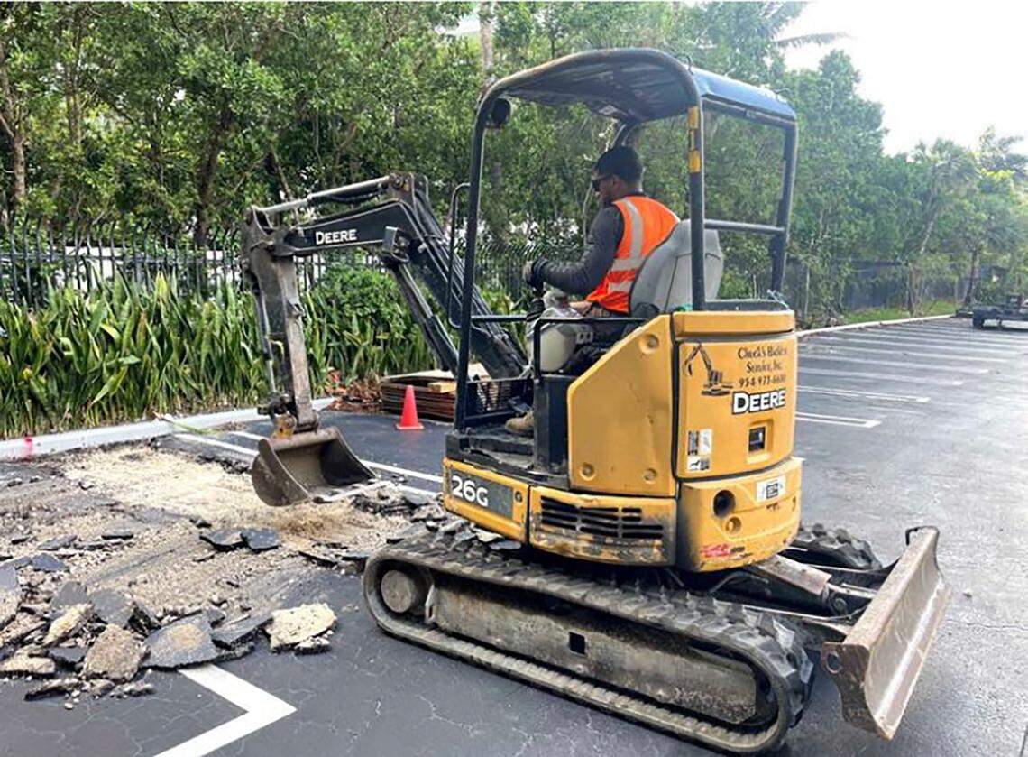 In a photo from a previously undisclosed October 2024 report submitted to the city of Miami, an archaeological worker uses a backhoe to excavate below an old parking lot at 1809 Brickell Avenue. Beneath the asphalt, archaeologists discovered a significant indigenous burial and settlement site dating back some 3,500 years.