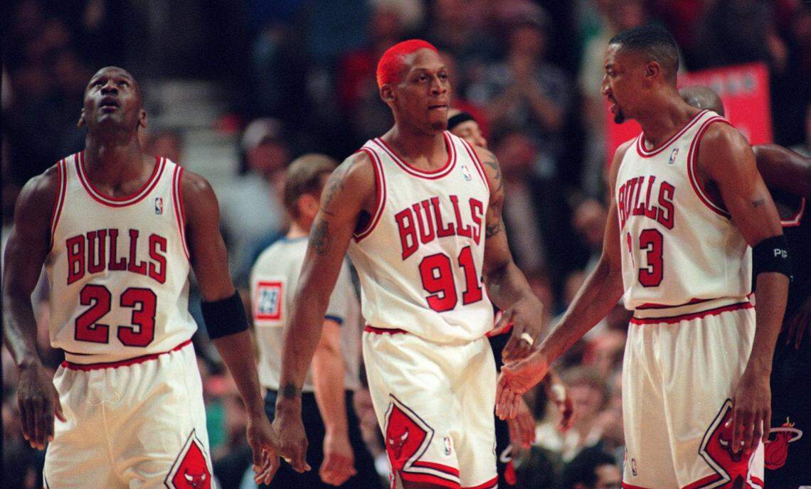 FILE PHOTO - Chicago Bulls’ Michael Jordan (23) looks up at the scoreboard as Dennis Rodman (91) and Scottie Pippen cross the floor during their first playoff game against the Miami Heat Friday, April 26, 1996, in Chicago. They became the first trio of teammates in 13 years to make the NBA’s all-defensive team, when the team was named on Thursday, May 9, 1996. This was not the game where the undermanned Heat squad beat the Bulls.