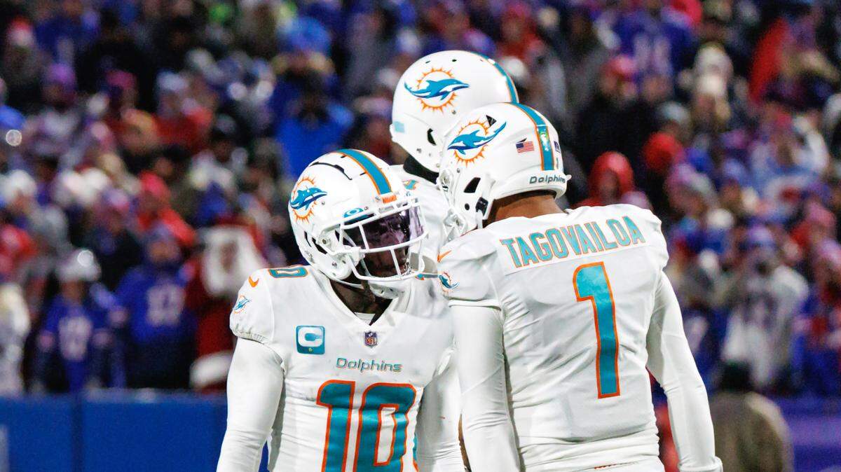 Miami Dolphins wide receiver Tyreek Hill (10) celebrates with teammate Tua Tagovailoa (1) after scoring a touchdown during third quarter of an NFL football game against the Buffalo Bills at Highmark Stadium on Saturday, December 17, 2022 in Orchard Park, New York.