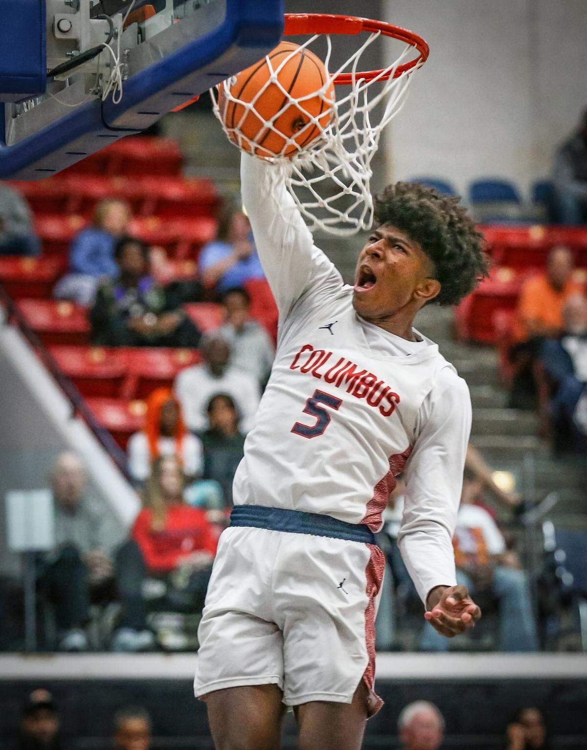 Columbus High School’s Jaxon Richardson (5) dunks the ball against Seminole High School in the first half for the FHSAA Class 7A Semi-Final for Boys High School Basketball State Championship.
