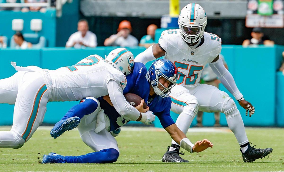 Miami Dolphins linebacker Bradley Chubb (2) and Miami Dolphins linebacker Jerome Baker (55) sack New York Giants quarterback Daniel Jones (8) in the first half at Hard Rock Stadium in Miami Gardens on Sunday.