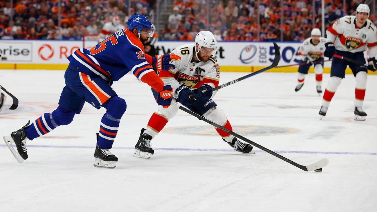 Jun 13, 2024; Edmonton, Alberta, CAN; Florida Panthers center Aleksander Barkov (16) battles Edmonton Oilers defenseman Darnell Nurse (25) for the puck in the first period in game three of the 2024 Stanley Cup Final at Rogers Place.