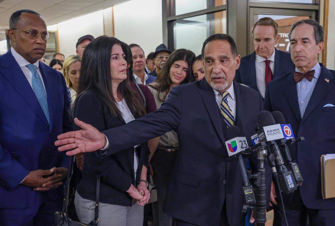 Surrounded by his lawyers, family, friends, and supporters, former Miami-Dade Commissioner Joe Martinez, center, take a moment to give his remarks after Judge Miguel de la O sentenced Martinez to a three-year prison sentence after being found guilty of public corruption on Monday, September 15, 2025, inside Courtroom 2-4 at the Richard E. Gerstein Justice Building in Miami, Florida.Martinez posted bail and will remain free while the appeals court rules that de la O may issue a sentence lower than what's in the sentencing guidelines.