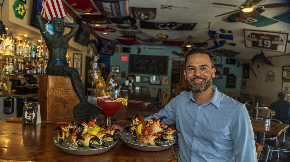 Owner Eric Castellanos displays a couple Stone Crab trays, ahead of the beginning of the Stone Crab season at the iconic Catch of the Day Restaurant on Lejeune Avenue in Miami, on Tuesday October, 14 2025.
