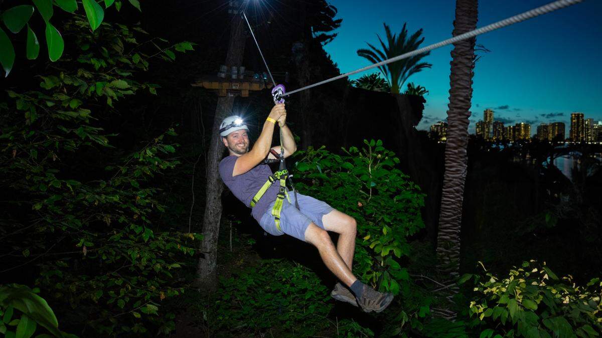 A participant of the Night Trek experience at Treetop Trekking Miami at Jungle Island, on Watson Island in Miami.