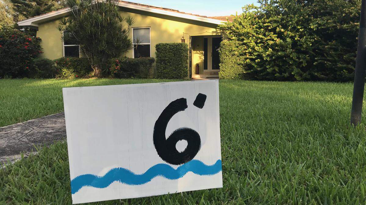 Artist Xavier Cortada suggests that South Florida homeowners recycle their campaign signs to make a statement about sea level rise.