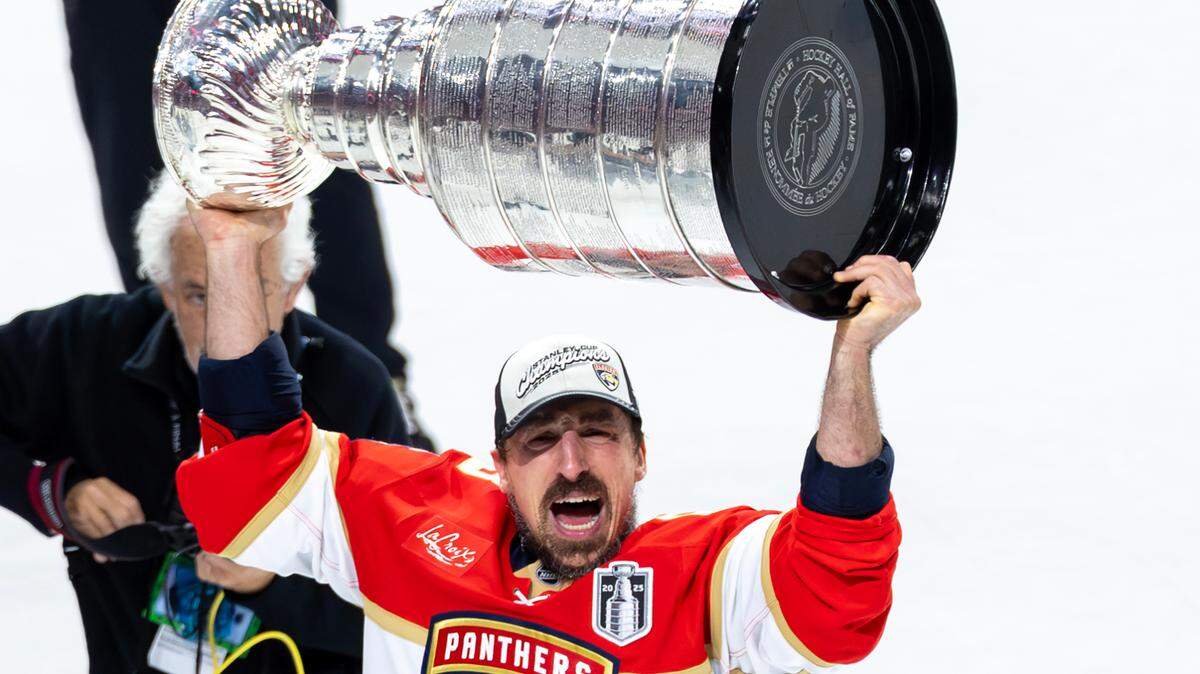 Florida Panthers center Brad Marchand (63) lifts the Stanley Cup after defeating the Edmonton Oilers 5-1 in Game 6 of the Final at Amerant Bank Arena in Sunrise, Fla., on Tuesday, June 17, 2025, clinching the NHL championship.
