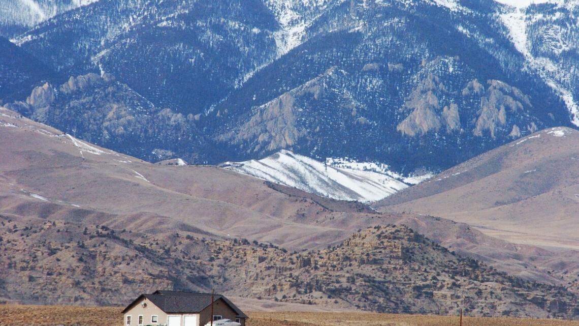 The Beartooth Mountains rise up behind a house in Clark, Wyo., Tuesday, March 5, 2013, where a woman and her parents where killed during an alleged vehicle theft. The violence has tested residents’ perceptions of safety in the rural, agriculture-centered community. (AP Photo/Matthew Brown)