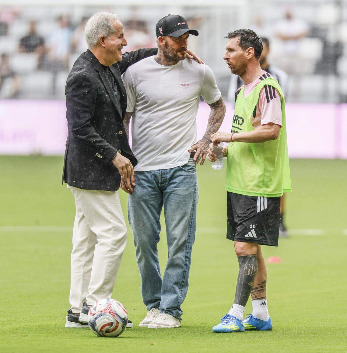 Inter Miami CF Managing Owner Jorge Mas, co-owner David Beckham and forward Lionel Messi (10), left to right, talk in the rain at Nu Stadium at Miami Freedom Park on Thursday, April 2, 2026, in Miami.