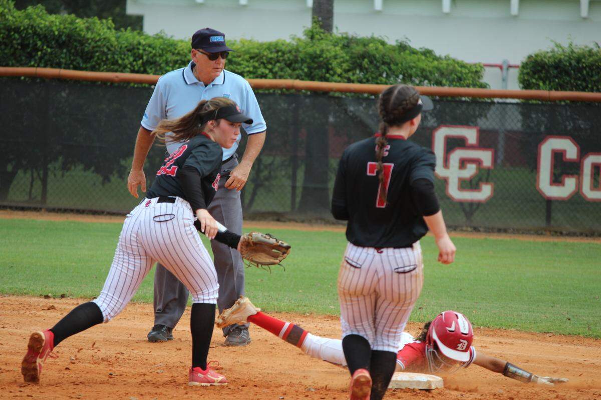 Doral’s Zoey Abdullah slides back safe at second after getting caught in a rundown between second and third during the Firerbirds’ 5-2 win over Cooper City on Saturday at Cooper City.