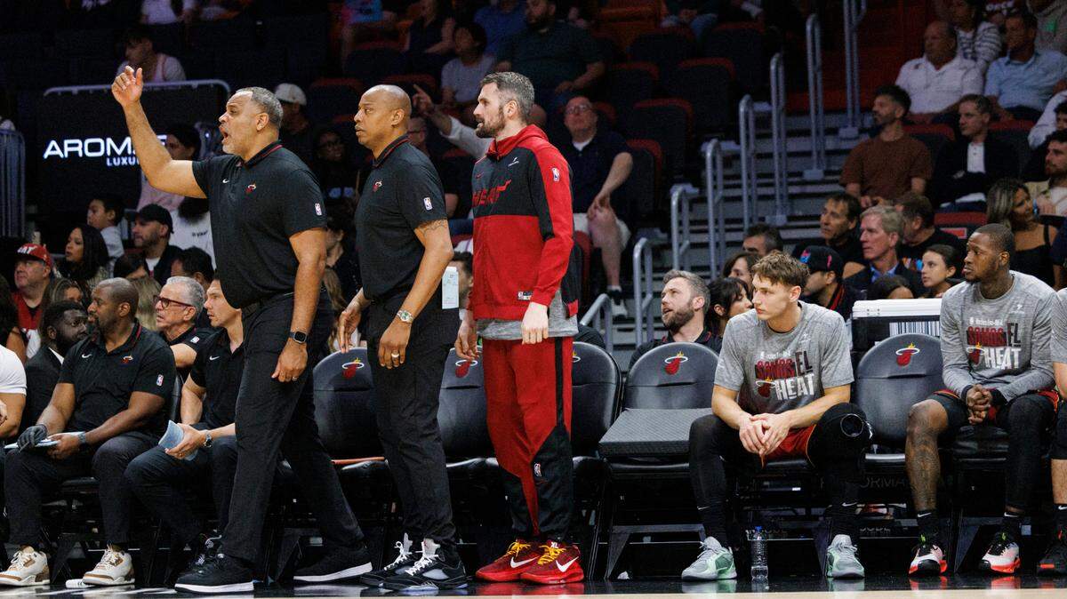 Miami Heat forward Kevin Love (42) and assistant coaches stand up during the second half of a game against the Charlotte Hornets on March 10, 2025, at Kaseya Center in Miami.