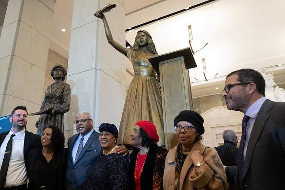 Members of the family of civil rights activist Barbara Rose Johns of Virginia pose with her statue following a dedication and unveiling ceremony in Emancipation Hall on Capitol Hill in Washington, DC, on December 16, 2025. In 1951, a 16-year-old Johns, led a walkout at her segregated high school, and now her statue replaces one of confederate General Robert E. Lee, which was removed from the Capitol in 2020. (Photo by SAUL LOEB / AFP via Getty Images)