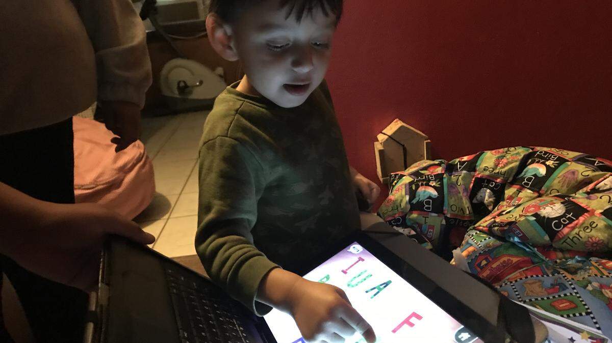 Nelson Moran, 3, gets his first look at a new tablet loaded with learning apps for children with autism. According to a study by the CDC, African American and Hispanic children are less likely to be diagnosed with autism than their non-Hispanic white counterparts. The delay in diagnosis can delay their treatment.