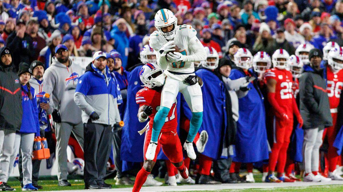 Miami Dolphins wide receiver Jaylen Waddle (17) catches a pass Buffalo Bills cornerback Tre’Davious White (27) during second quarter of an NFL football game at Highmark Stadium on Saturday, December 17, 2022 in Orchard Park, New York.