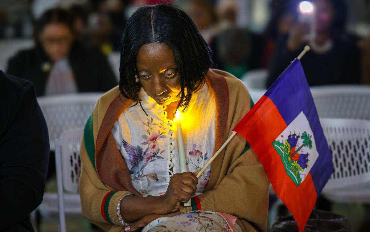 Linda Joseph, a community activist, silently prays during the TPS prayer candlelight vigil as public officials from Miami-Dade County, the City of Miami and North Miami, along with community members, gathered for a TPS candle light prayer vigil at the Little Haiti Cultural Complex on Feb. 3, 2026, in Miami. The event, held in support of the local TPS community, included prayer, reflection and calls for unity and hope.