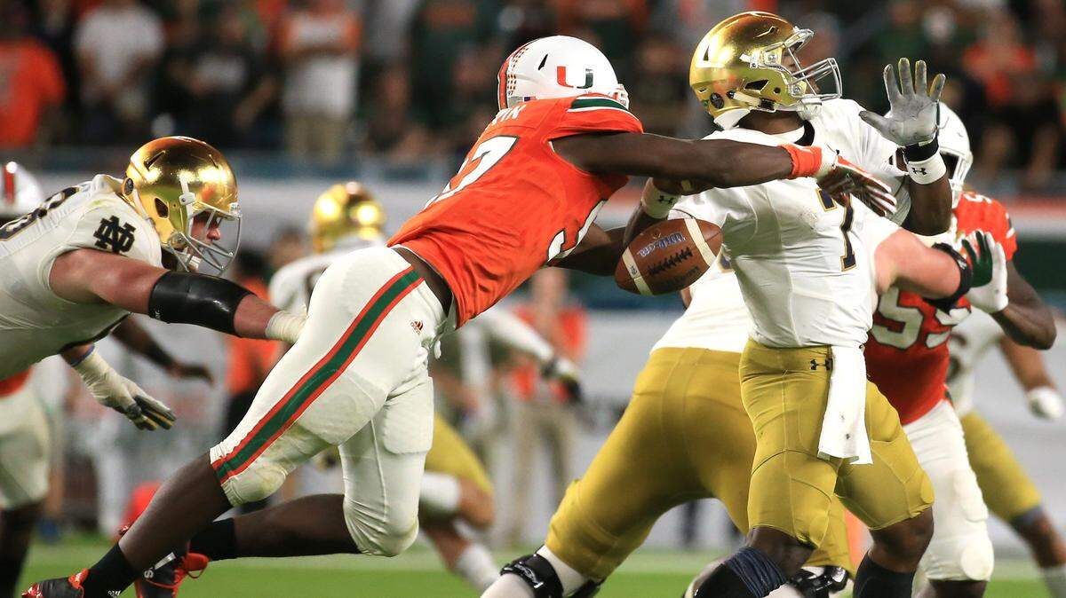 Miami Hurricanes defensive lineman Jonathan Garvin (97) knocks the ball out of Notre Dame Fighting Irish quarterback Brandon Wimbush (7) in the fourth quarter of a big UM win on Nov. 11, 2017.