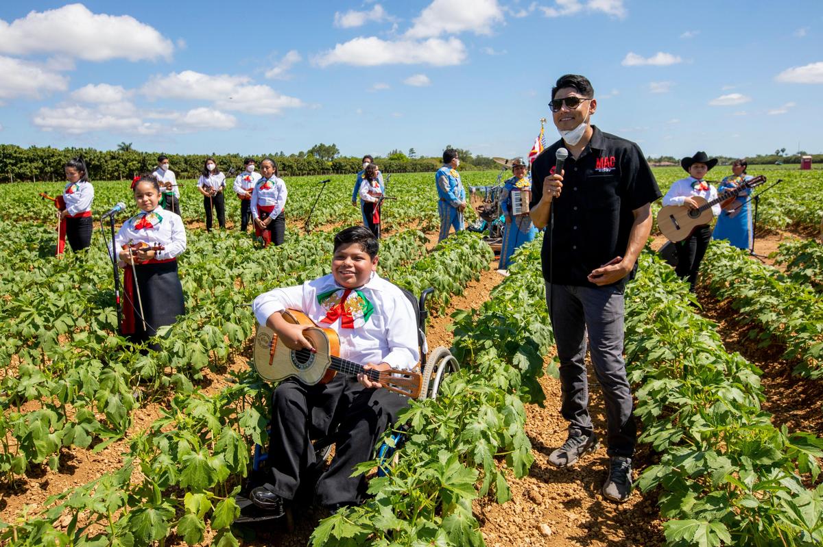 Mexican-American Council leader Eddie Garza speaks to viewers watching the Homestead-Miami Mariachi Conservatory students during a Facebooklive event as they perform at a Cinco de Mayo celebration hosted by Mexican-American Council, with Congresswoman Debbie Mucarsel-Powell in attendance, at Sifuentes Farms in Homestead, Florida on Tuesday, May 5, 2020.