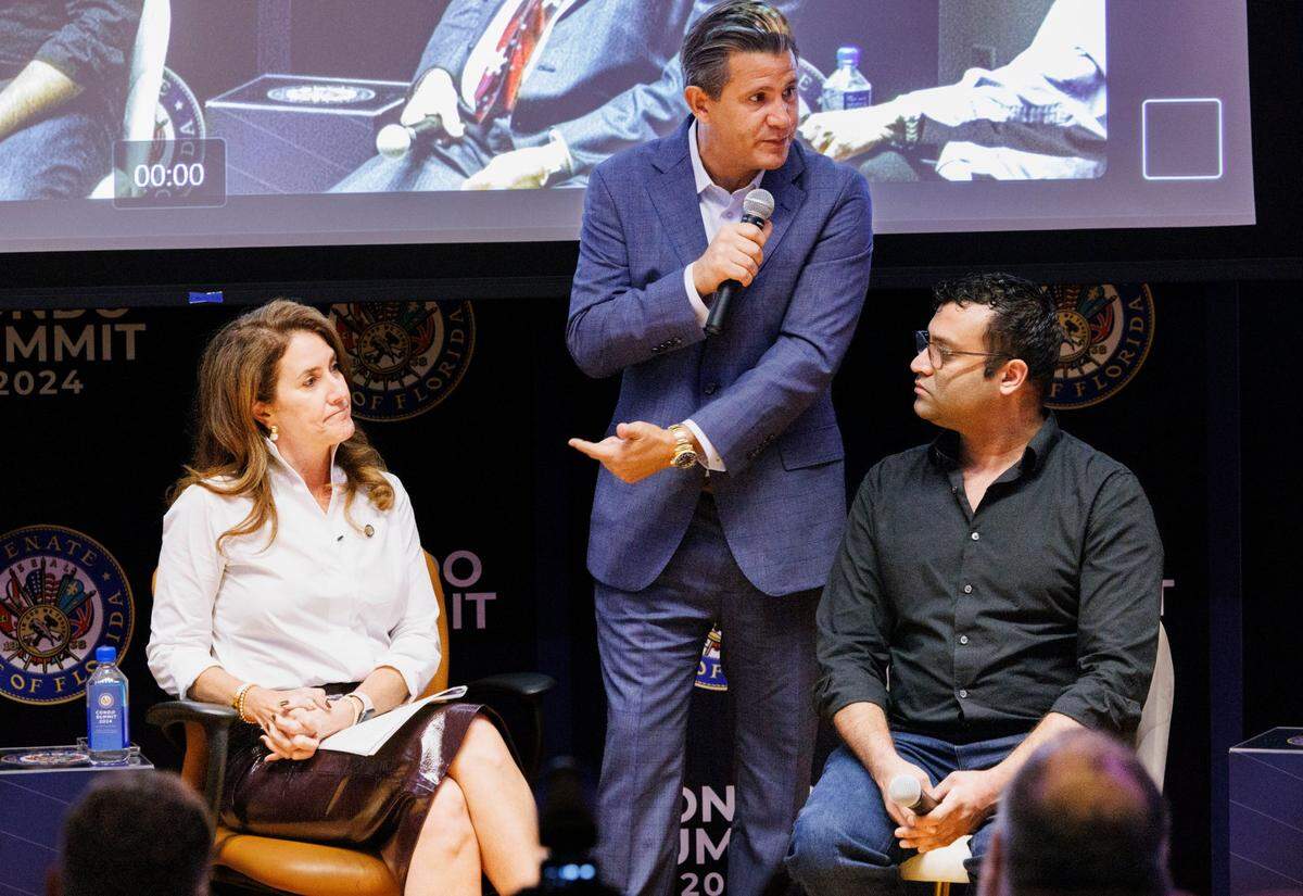 Florida Senators Jennifer Bradley, left, and Jason Pizzo, center, talk to the panelists during the “Risk Management” session of the Condo Summit 2024 on Tuesday, Dec. 3, 2024, at the Liberal Arts Building at Florida Atlantic University in Davie.