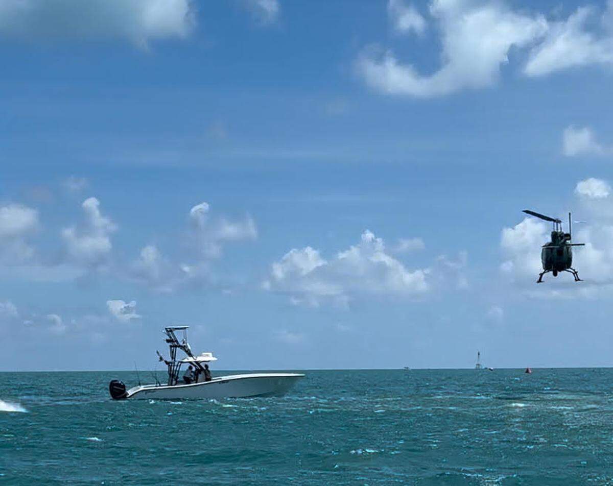 A Florida Fish and Wildlife Conservation Commission helicopter pilot positions his aircraft in front of a 36-foot boat to stop it from entering an area where people were competing in the Swim For Alligator Lighthouse race in the Florida Keys Saturday, Sept. 7, 2024. The boater is facing a boating under the influence charge.