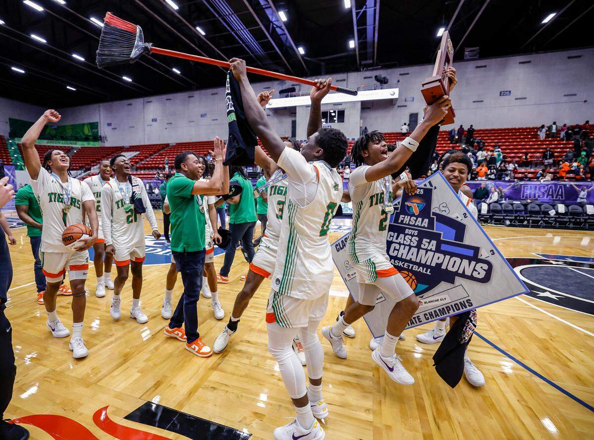 Blanche Ely Tigers celebrate on the court after defeating Ponte Vedra in the FHSAA Class 5A Final for Boys High School Basketball State Championship.