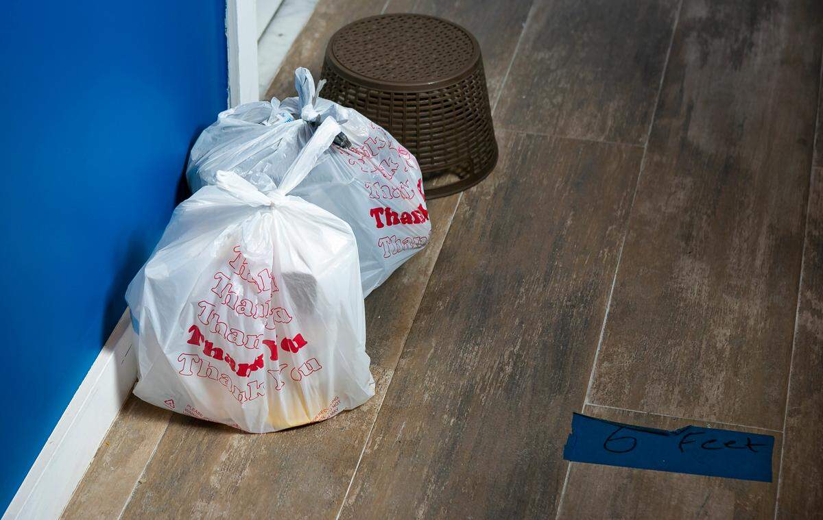 A bag with food sits outside of an occupied room inside the Dunns Josephine Hotel in MiamiÕs Overtown neighborhood on Saturday, August 22, 2020.The owner of the hotel, Kristin Kitchen, partnered with the Homeless Trust to house folks without a home who are at risk of contracting COVID-19 or became infected.