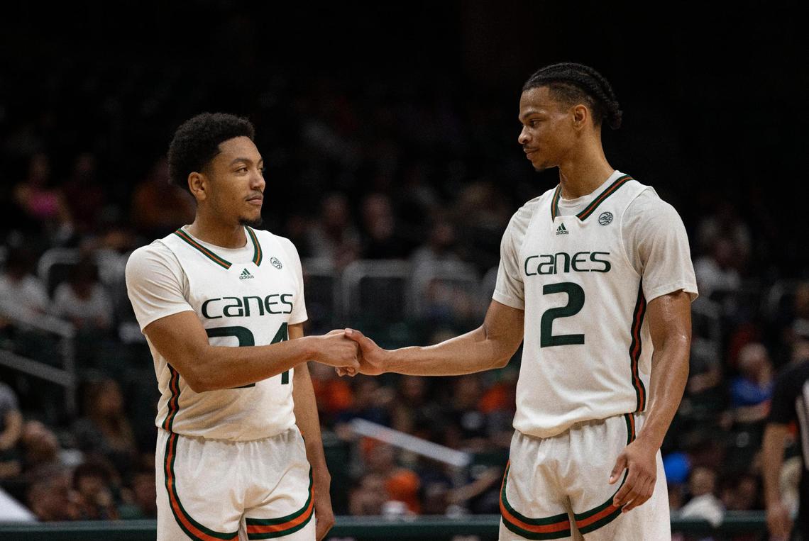 Miami guard Nijel Pack (24) high fives teammate Isaiah Wong (2) during the second half of a NCAA men’s basketball game between the University of Miami Hurricanes and the St. Francis Brooklyn Terriers on Wednesday, Nov. 23, 2022, at the Watsco Center in Coral Gables. Miami won 79-56.