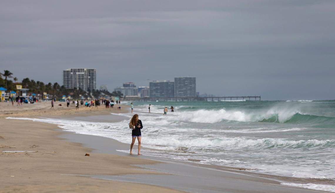 Strong waves crash on the beach as people visit the Hollywood Beach Broadwalk on Monday, Feb. 19, 2024, in Hollywood, Fla. After strong winds and rain showered parts of South Florida on Sunday, the temperature dipped into the mid-60s Monday morning.