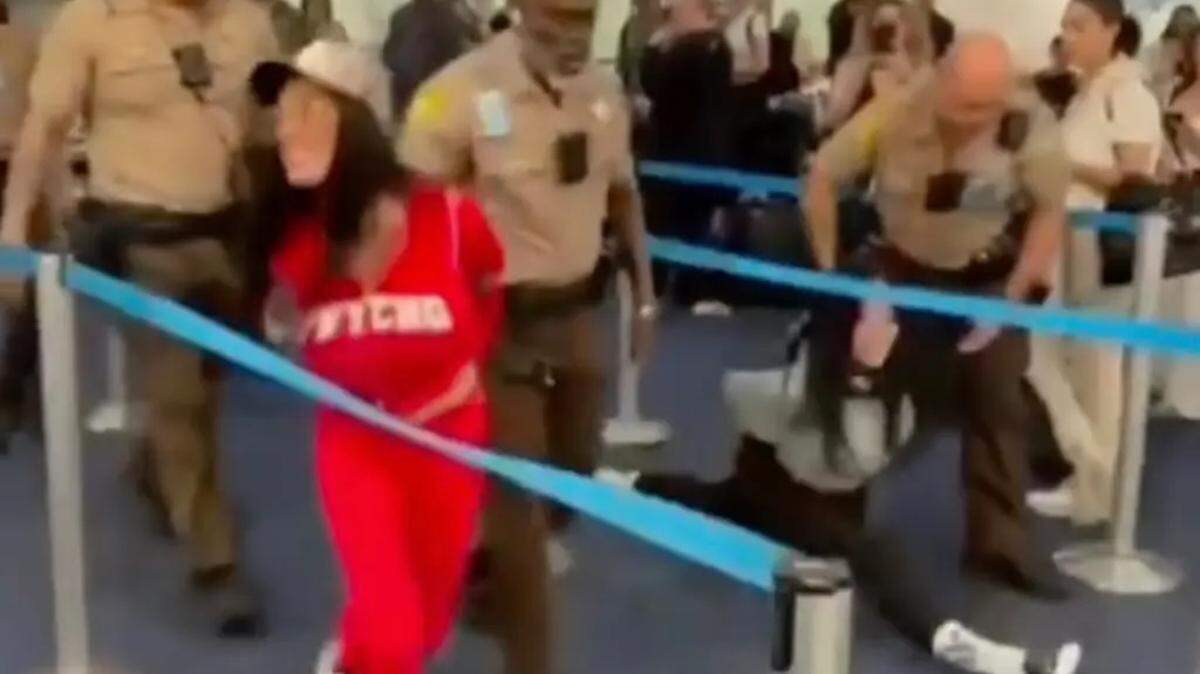 Sania Blanchard yells out as Jordan Lantry does a split during their arrest at Miami International Airport on Jan. 9, 2026.
Lacey Jayne/Instagram