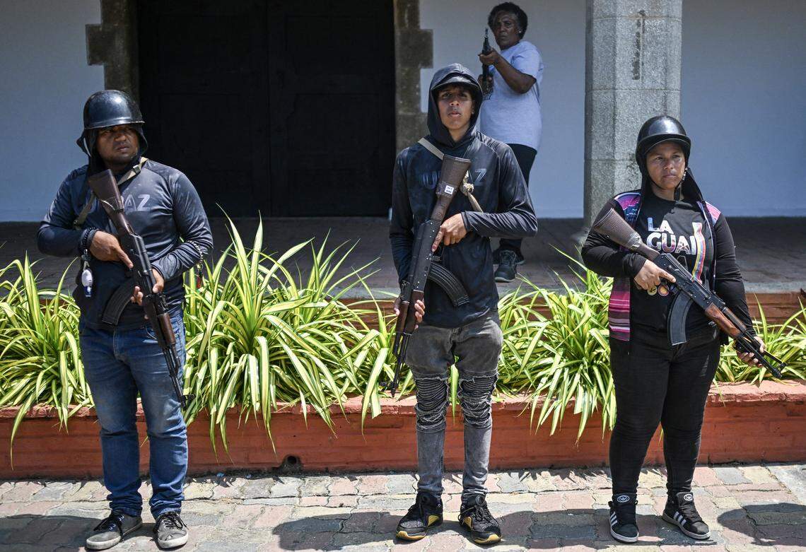 Members of the Bolivarian National Militia hold rifles during a military training in La Guaira, Venezuela, on Oct. 8, 2025. 