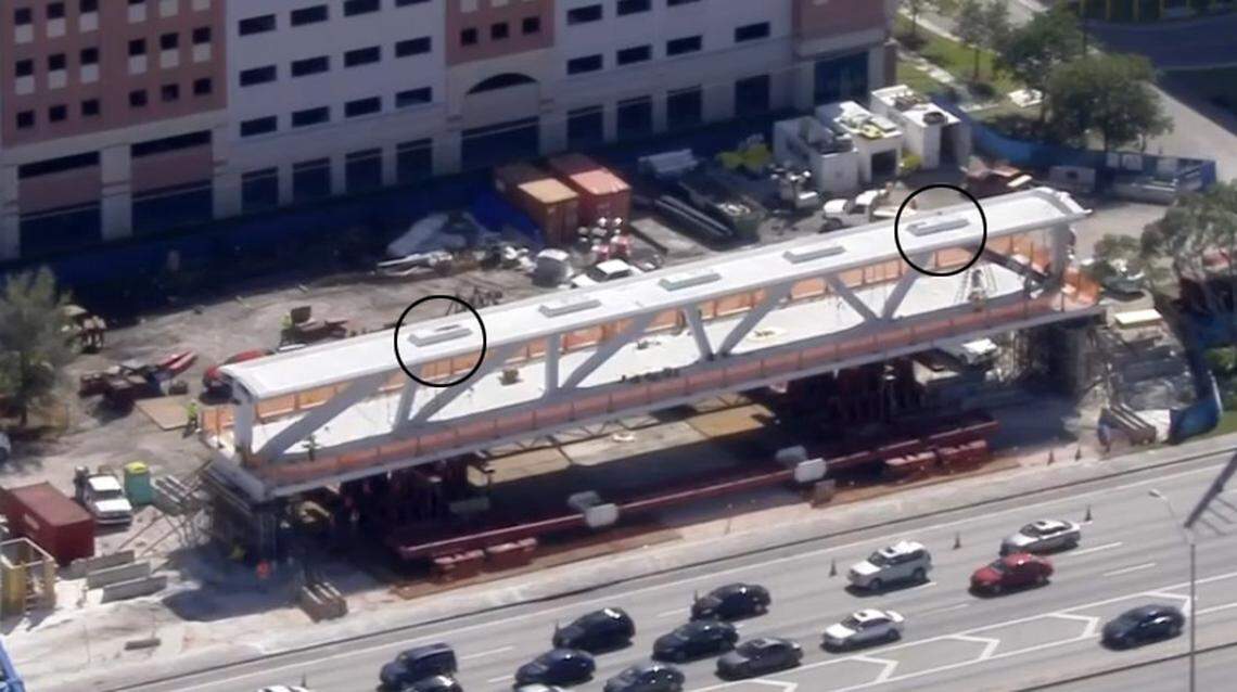 Workers stood on top of the bridge where they attached a hydraulic jack to tensioning rods. The rods were accessed through the protruding structures above the juncture of each support strut and the bridge’s canopy.