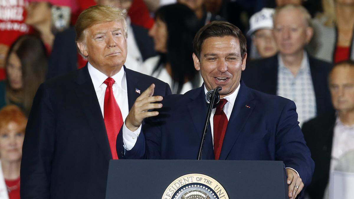 President Donald Trump stands behind gubernatorial candidate Ron DeSantis as he speaks at a rally, Saturday, Nov. 3, 2018, in Pensacola.