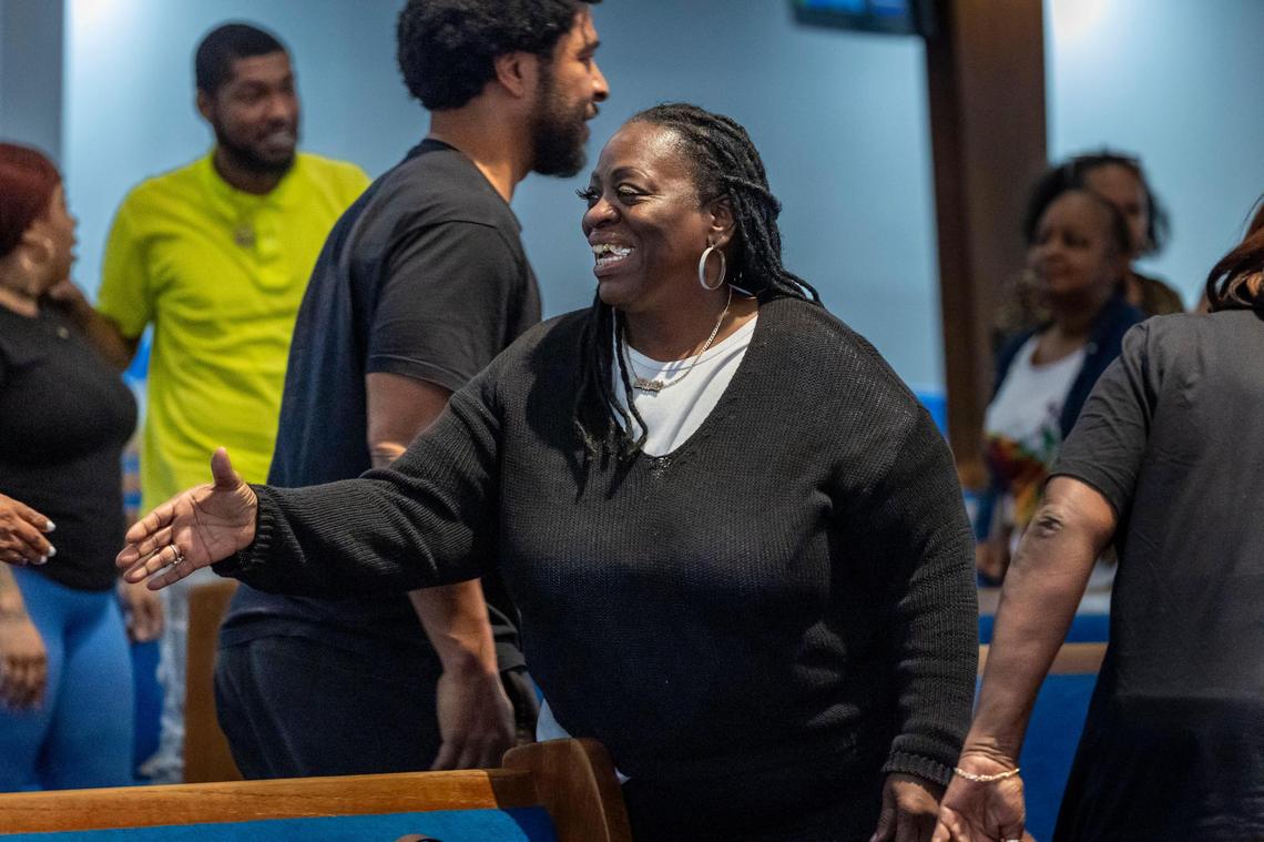 Miami, Florida, February 27, 2024- Evette Burton, center, greets other members of the congregation of New Shiloh Missionary Baptist Church during a Tuesday Mid-week Service.