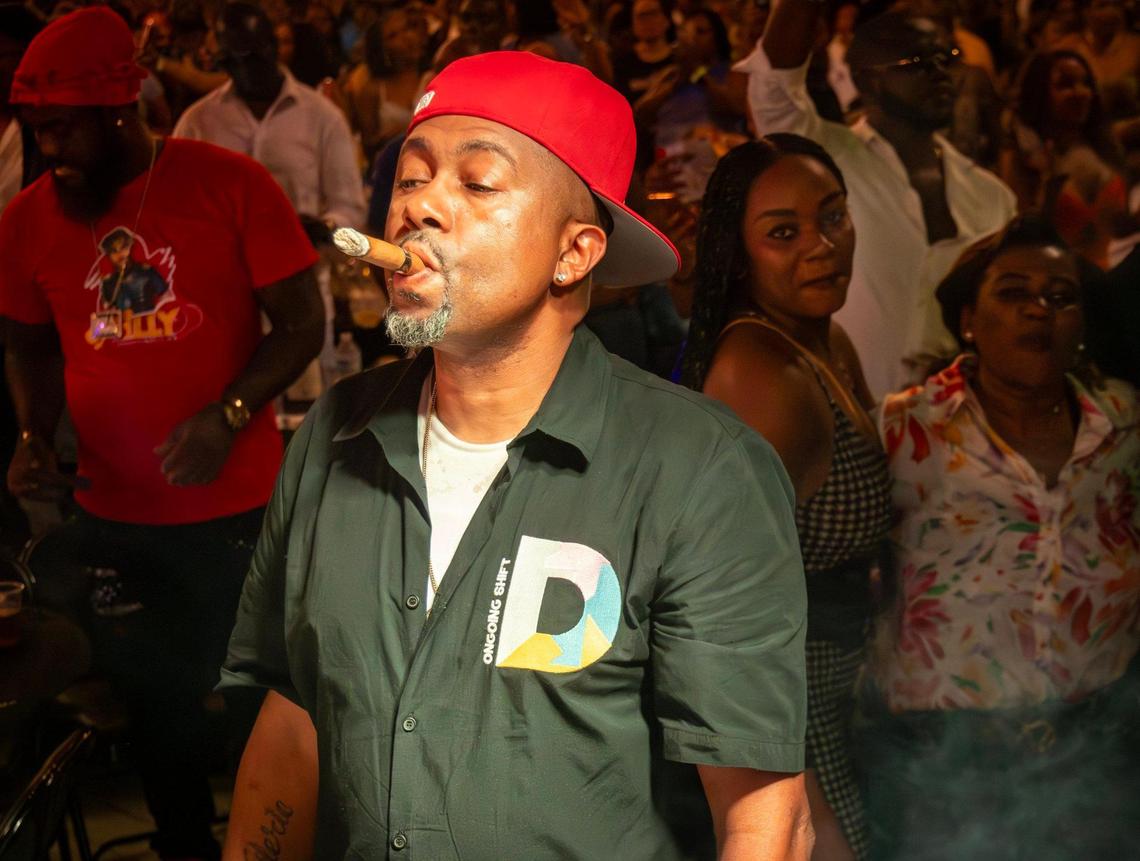 A kompa fan enjoys his cigar as Richard Cave performs with his band KAI and delivers another electrifying performance on Friday, June 20, 2025, at “Sounds of Little Haiti” in Miami, Florida.