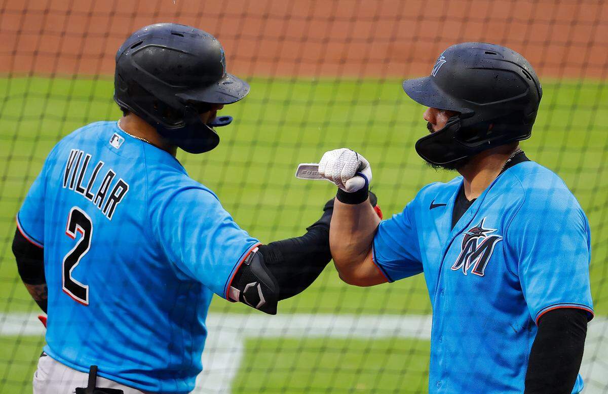 Jorge Alfaro of the Miami Marlins reacts with Jonathan Villar after hitting a solo homer in the third inning against the Atlanta Braves during an exhibition game at Truist Park on July 21, 2020 in Atlanta, Georgia.